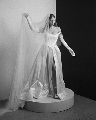 Vivienne Westwood Grand Camille dress in ivory satin, highlighting exclusive made-to-order luxury and signature design elements.