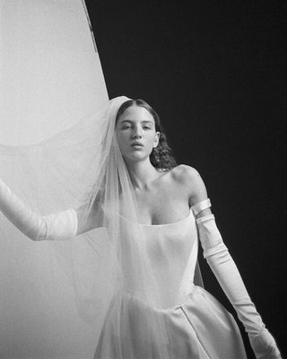 Vivienne Westwood couture wedding gown with bold pleated skirt, draped satin, and iconic corsetry, crafted for timeless elegance.