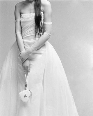 Vivienne Westwood couture bridal gown in ivory satin, emphasizing exclusivity, craftsmanship, and the heritage of British high fashion.