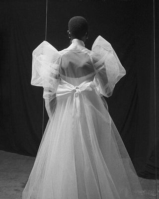 Back view of the Elizabeth Coat by Vivienne Westwood in recycled tulle and organza, featuring voluminous pleated sleeves and a dramatic bubbly hemline inspired by Victorian opera coats.