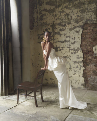 Full body front view of the Cora Skirt in white, highlighting the hourglass silhouette and sweeping train in a styled bridal setting.