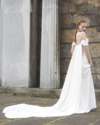 Vivienne Westwood luxury bridal gown with detachable Watteau cape, blending artisanal details and sustainable couture materials.
