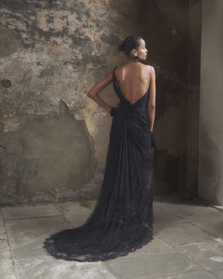 Back view of the Lace Minerva gown in black, highlighting its stunning design and soft pleats at the back.