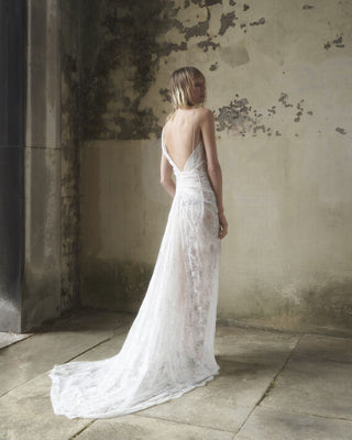 Diagonal-back view of the Lace Minerva gown in white, highlighting the stunning silhouette and exquisite lace details.