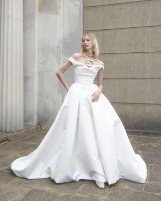 Front view of the Nova Bagatelle gown highlighting the cinched waist and pleated skirt.
