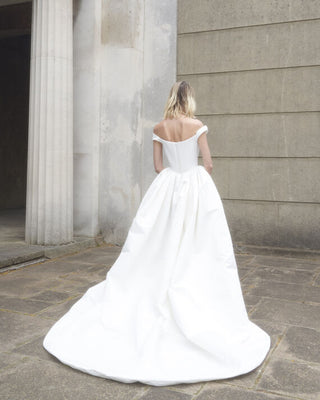 Back view of the Nova Bagatelle gown emphasizing the elegant train and draping.