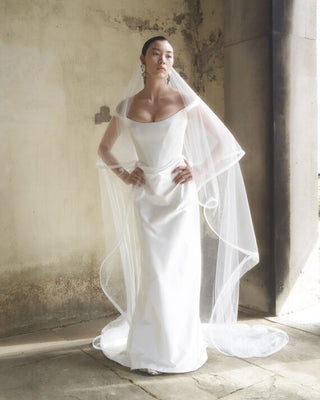 Vivienne Westwood couture bridal gown featuring off-the-shoulder design and luxurious Naia stretch satin for a bespoke, modern silhouette.