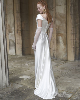 Vivienne Westwood bespoke wedding dress featuring a Bardot neckline, corseted bodice, and artisanal draping in silk cady.
