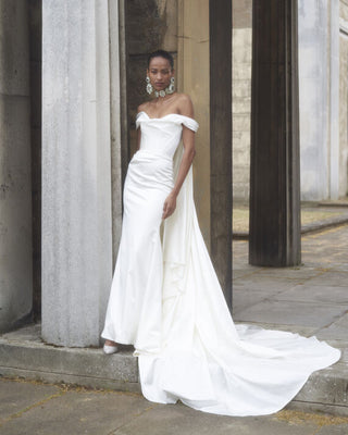 Front view of the Nova Cora gown by Vivienne Westwood, showcasing the fitted corset and draped neckline in luxurious stretch satin.