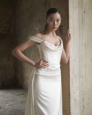 Vivienne Westwood luxury bridal dress featuring off-the-shoulder sleeves and bespoke draping for an exclusive wedding look.