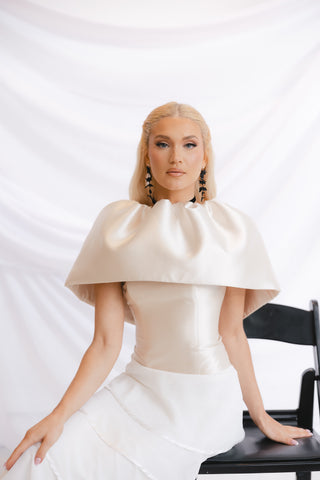 Luxurious strapless wedding gown with expert tailoring, a fitted silhouette, and cascading ruffle details for a statement-making look.