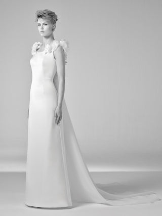Viktor&Rolf couture column gown in ivory crepe with artisanal floral appliqués and bespoke Watteau train, embodying luxury bridal design heritage