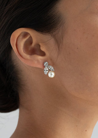Handcrafted designer earrings with a delicate drop silhouette, adorned with sparkling crystals and a signature pearl detail.