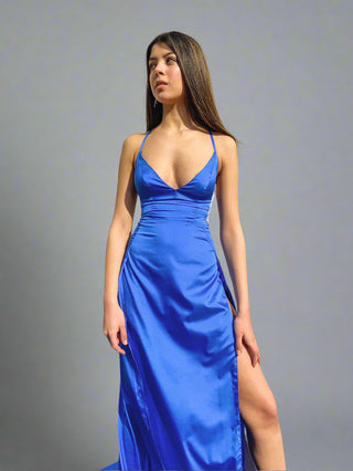Sleek column gown with plunging neckline, adjustable spaghetti straps, and daring double high slits for bold sophistication.