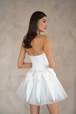 Sophisticated mini dress with a structured silhouette and charming bow embellishments