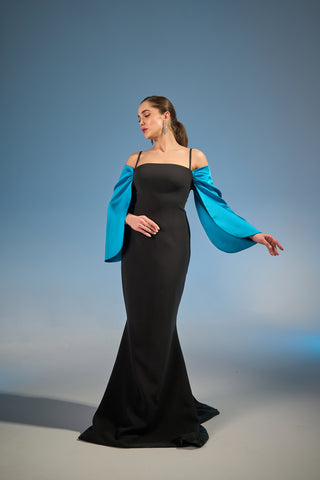 Sophisticated column gown with a straight neckline, delicate spaghetti straps, and flowing off-shoulder sleeves.