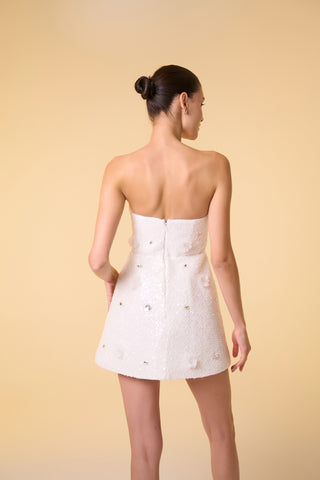 Modern A-line mini dress with floral appliqués and a strapless neckline, crafted for receptions and formal occasions.