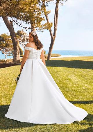 Back view of Dimitra gown with dramatic overskirt and dropped shoulders.