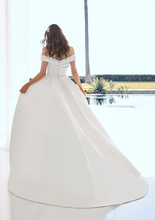 Back view of Dimitra gown with dramatic overskirt and dropped shoulders.