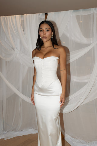 Luxurious crepe bridal gown featuring a suit-inspired button-up corset bodice and a figure-skimming silhouette