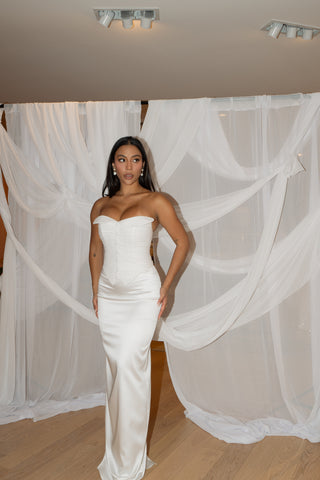 Contemporary wedding dress with a structured fit, corset-style bodice, and refined button details for a polished look