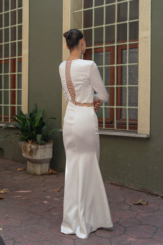 Bridal gown designed with a fitted bodice, tailored long sleeves, and a flattering column silhouette for timeless sophistication.