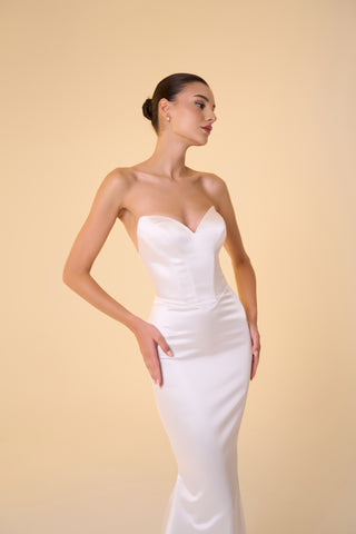 Luxurious mermaid bridal gown with sleek drop waist, sleeveless design, and soft flared hem ideal for formal wedding celebrations