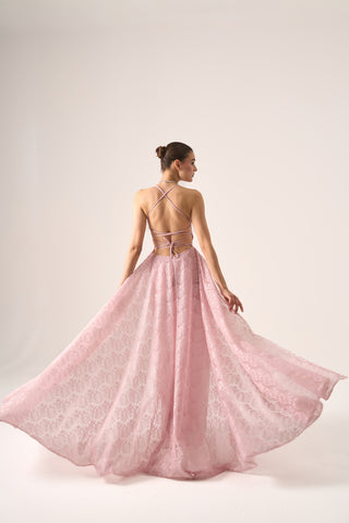 Model extending the train of Erina lace gown sideways, highlighting the intricate lace overlay and elegant silhouette.