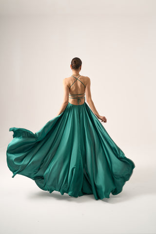 Elegant A-line evening gown featuring a plunging neckline, spaghetti straps, and a gracefully flowing silhouette.