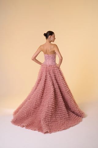 Timeless maxi ball gown featuring a sleeveless tulle design, floral embellishments, and a flowing ruffled skirt.