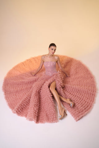 Elegant formal gown with cascading ruffles, floral accents, and a timeless strapless, sleeveless design.