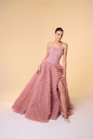 Strapless ball gown with cascading ruffled layers and delicate floral accents, designed for elegant evening events.