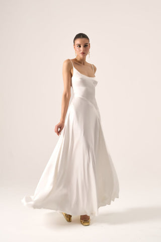 Luxury bridal gown featuring delicate spaghetti straps, fluid silk fabric, and a flattering slip-style silhouette