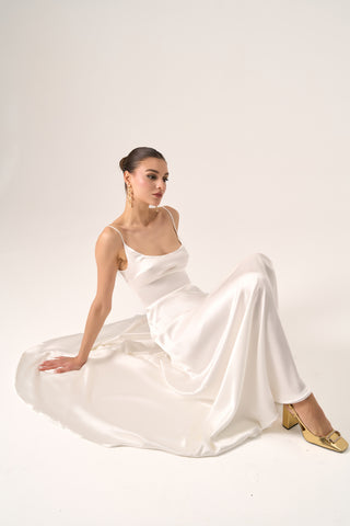 Effortlessly elegant bridal gown with a slip style, delicate straps, and a cascading silhouette