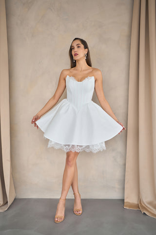 Mini A-line evening dress with structured corset bodice, sweetheart neckline, and layered hemline for an elegant touch.