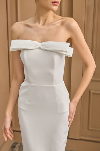 Bridal midi dress featuring a sleek sleeveless design, structured corset bodice, and modern silhouette for a sophisticated wedding look.
