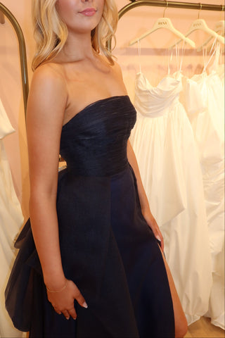 Sophisticated ball gown with a strapless neckline and flowing layered tulle skirt.