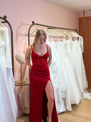 Elegant floor-length dress featuring a fitted mermaid silhouette, structured bodice, and a daring side slit for added allure.