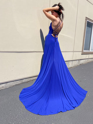 Floor-length evening dress featuring a plunging neckline, delicate spaghetti straps, and a striking column silhouette.