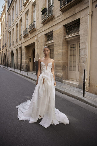 Front view of the Joan gown by Liz Martinez featuring a plunging neckline, 3D floral appliqués, and thigh-high slit.