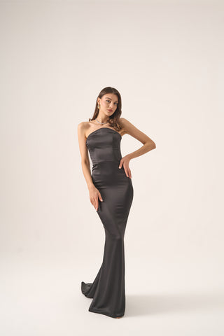 Formal mermaid gown with a sleek strapless neckline, impeccable tailoring, and a flowing train ideal for special occasions.