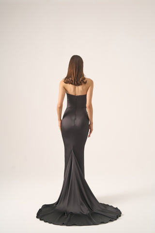 Strapless maxi gown with a figure-hugging bodice and dramatic flare, crafted in satin for ultimate elegance and luxury.