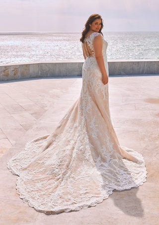 Elegant wedding gown with lace bodice and beaded embellishments.