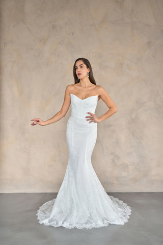 Mermaid bridal gown with a fitted bodice, structured sweetheart neckline, and flowing floor-length train.