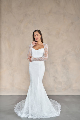 Luxury lace bridal gown with a tailored mermaid silhouette, floor-length train, and classic sweetheart neckline.