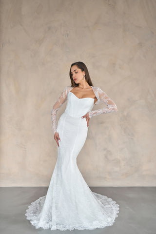 Wedding dress with a dramatic mermaid cut, structured bodice, and intricate lace accents for an elegant bridal statement.