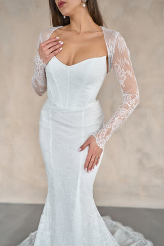 Lace mermaid bridal gown featuring a fitted design, sleeveless straps, and a sweeping train ideal for luxury weddings.
