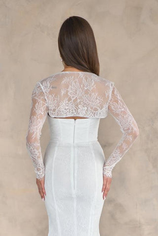 Delicate lace bridal bolero featuring vintage-inspired floral patterns, scalloped edges, and a soft, draped fit for sleeveless gowns.