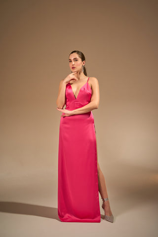 Hot pink dress featuring a sleek, modern design with a deep V-neckline, thigh-high slit, and smooth satin fabric for an elegant and daring look.