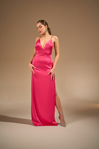Hot pink dress with a deep V-neckline and thin double straps, featuring a thigh-high slit for a bold and elegant look.